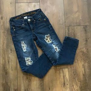 Justice leopard distressed patches skinny jeans.